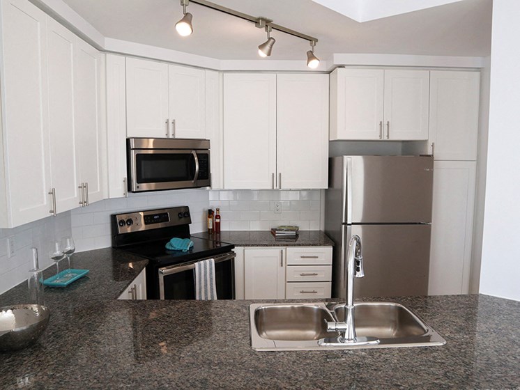 Updated Kitchen with Stainless Steel and White Cabinets